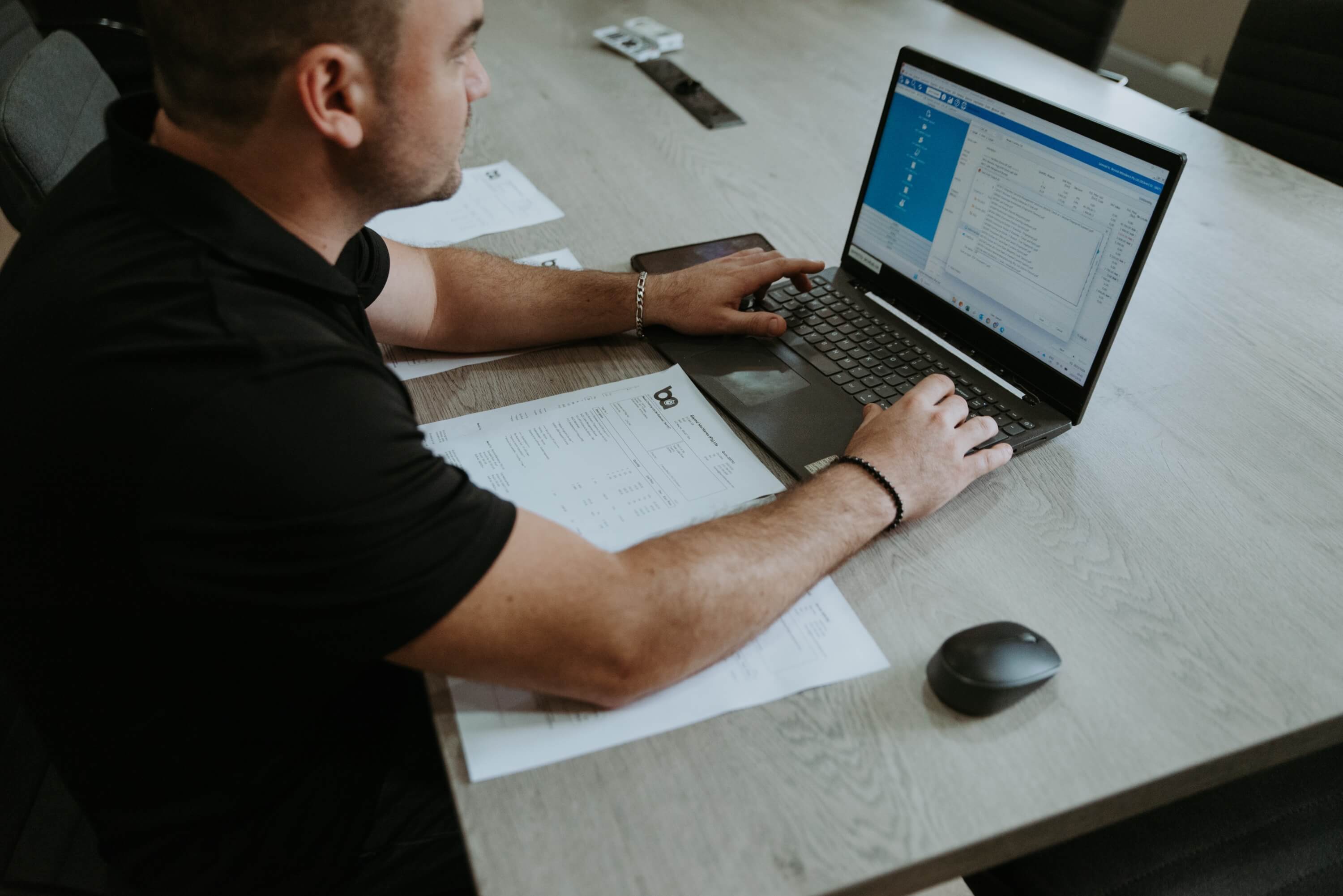 Payroll administrator processing automated time and attendance data integration with South African payroll systems