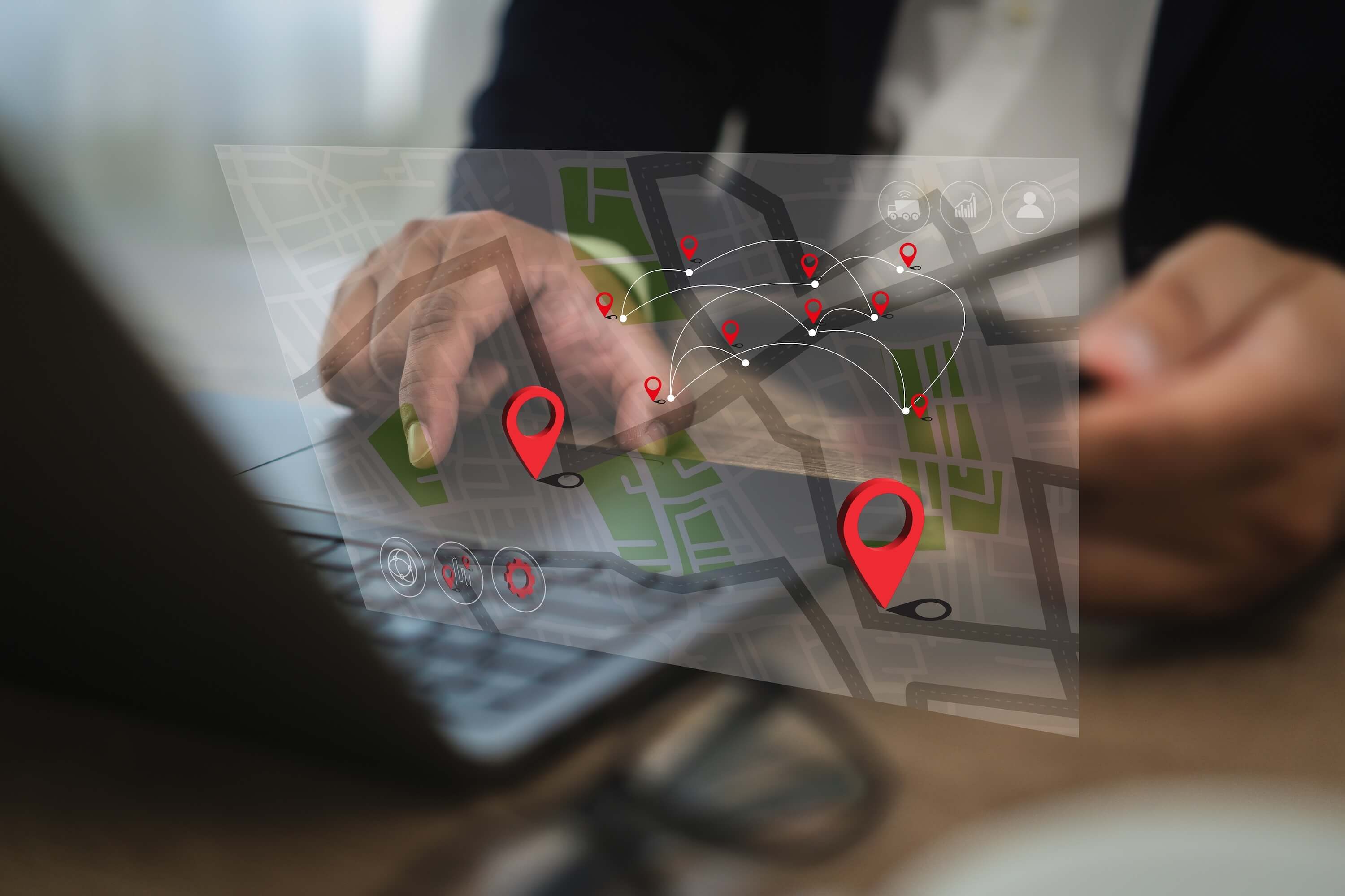 Business manager reviewing multi-location dashboard showing time attendance data from multiple retail stores and franchises across South Africa