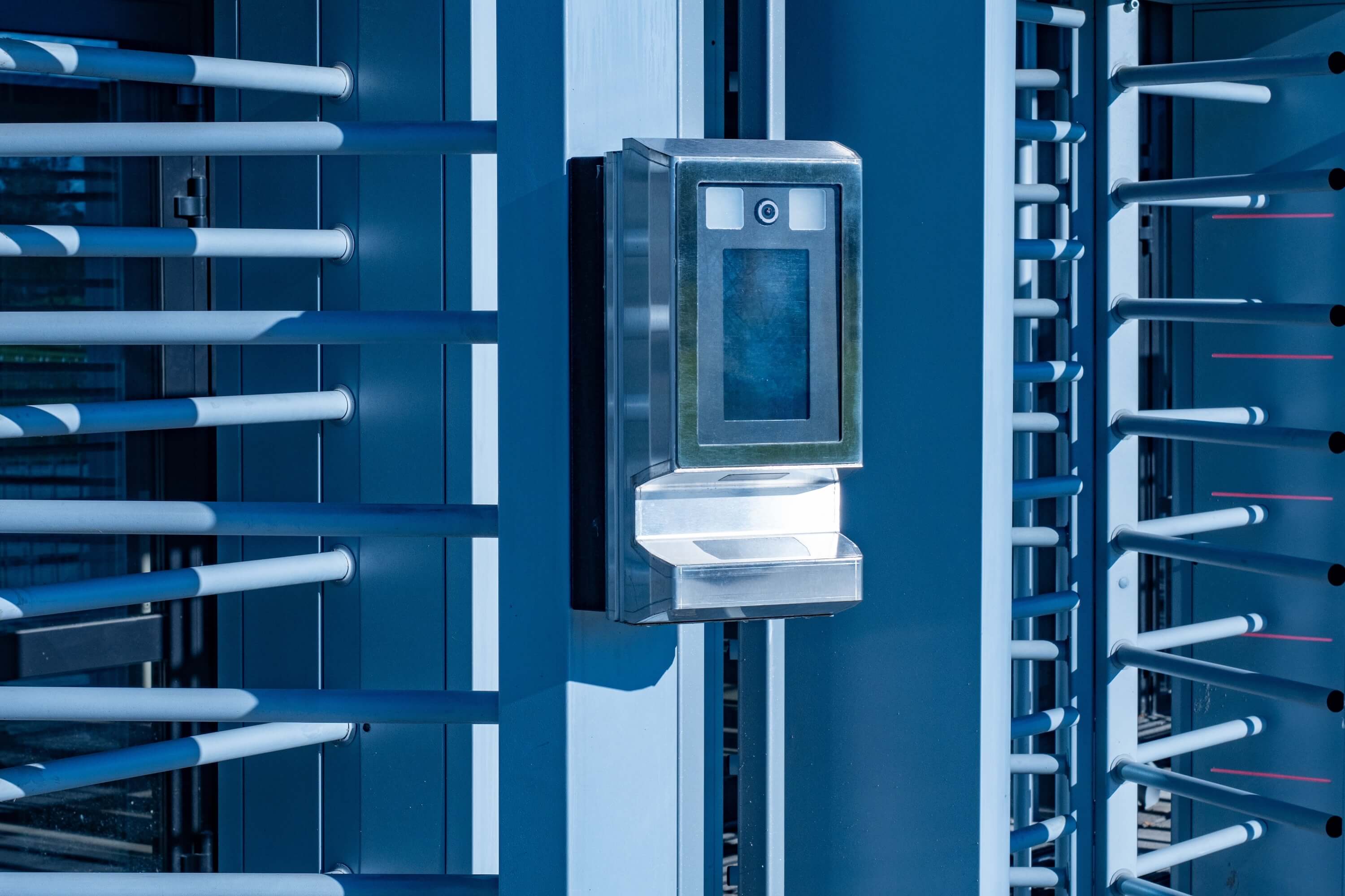 South African manufacturing workers in factory using biometric time attendance system for production hour tracking